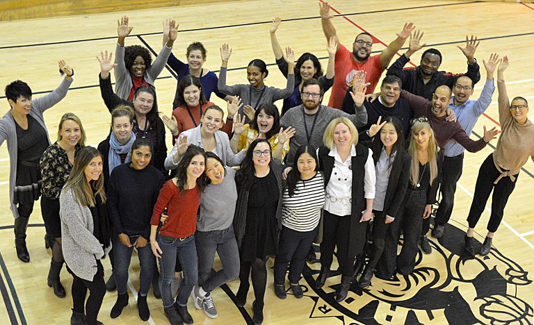 Group of happy people with hands in the air. Join the Covenant House team through our job listings for non profit roles helping the homeless and sex trafficking victims in Toronto