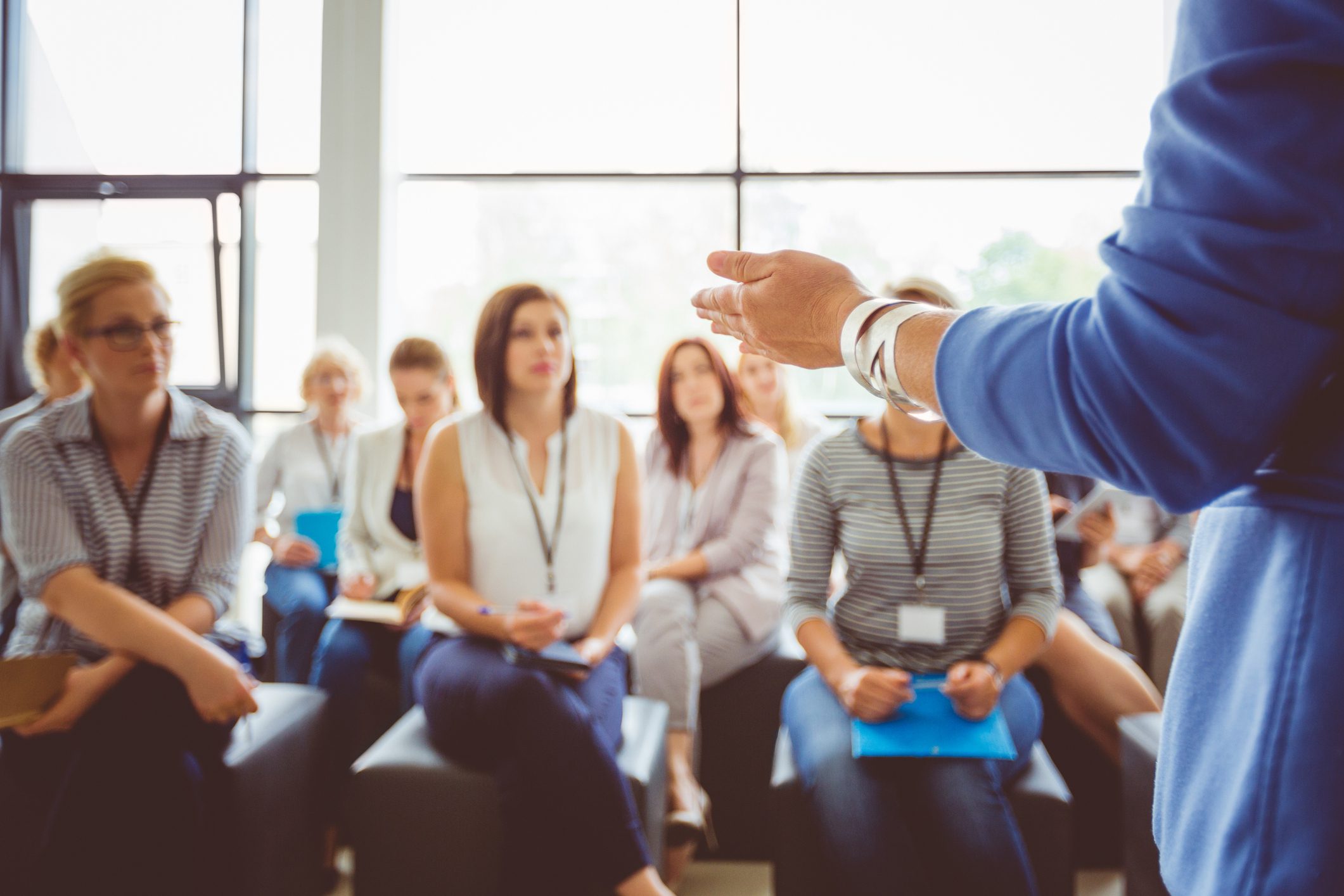 Individual delivering a presentation to a group of people.